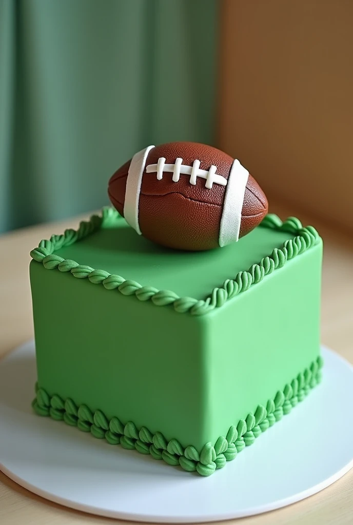 A green square-shaped cake with an American football 