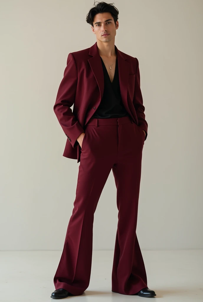 Male model with maroon loose blazer and maroon bell bottom Pants with black net tshirt inside