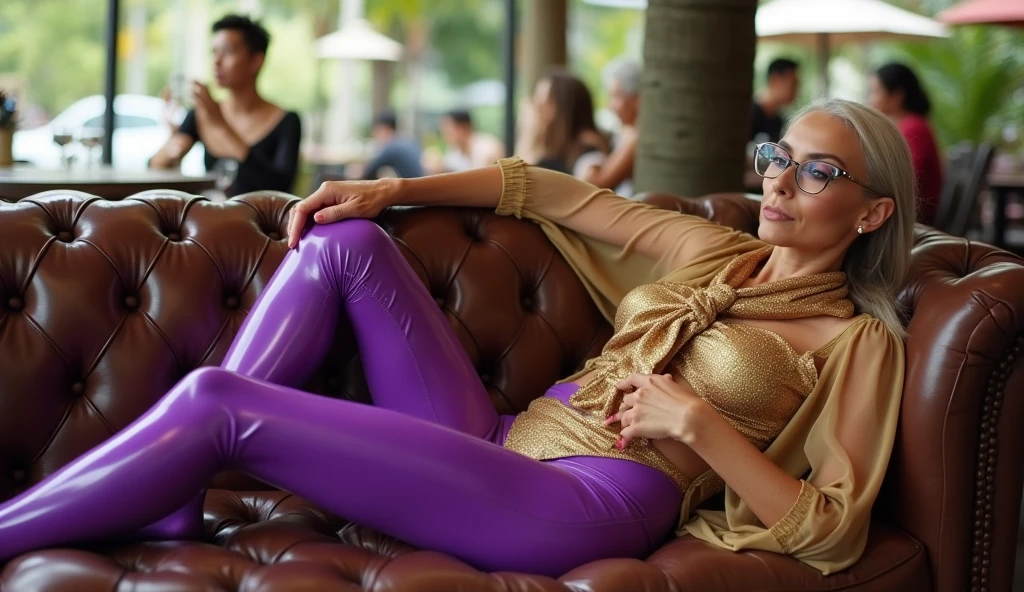 a liquid-lacquered purple leggings worn by a wrinkled face androgynous senior mature with intense makeup and massive much eyeshadow, intense deep and wide lot of eye shadow, smoky eyes, lounging with legs stretched out on the chesterfield lounge in a open cafeteria with palm trees, wearing a glossy leggings and a stretchy golden latex diapers, thai and filipino women fill the cafe in the background, point on the leggings, also wearing a transparent golden shimmering satin blouse with latex bolero and with tie
