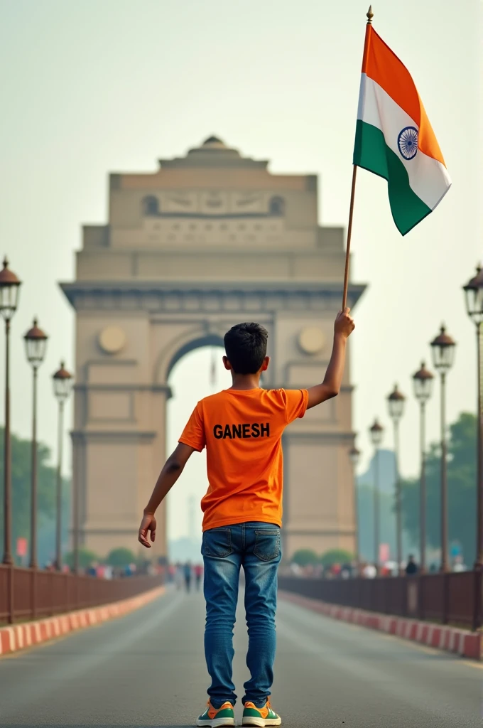 A real 20 years old boy, Wearing Orange T shirt blue jeans sneakers and the name "GANESH" is written on his t-shirt and the boy is standing on the road with holding a national flag of India, and behind him is the India gate Delhi. And "Happy Independence Day 2024" written at above sky Create Realistic image high quality.