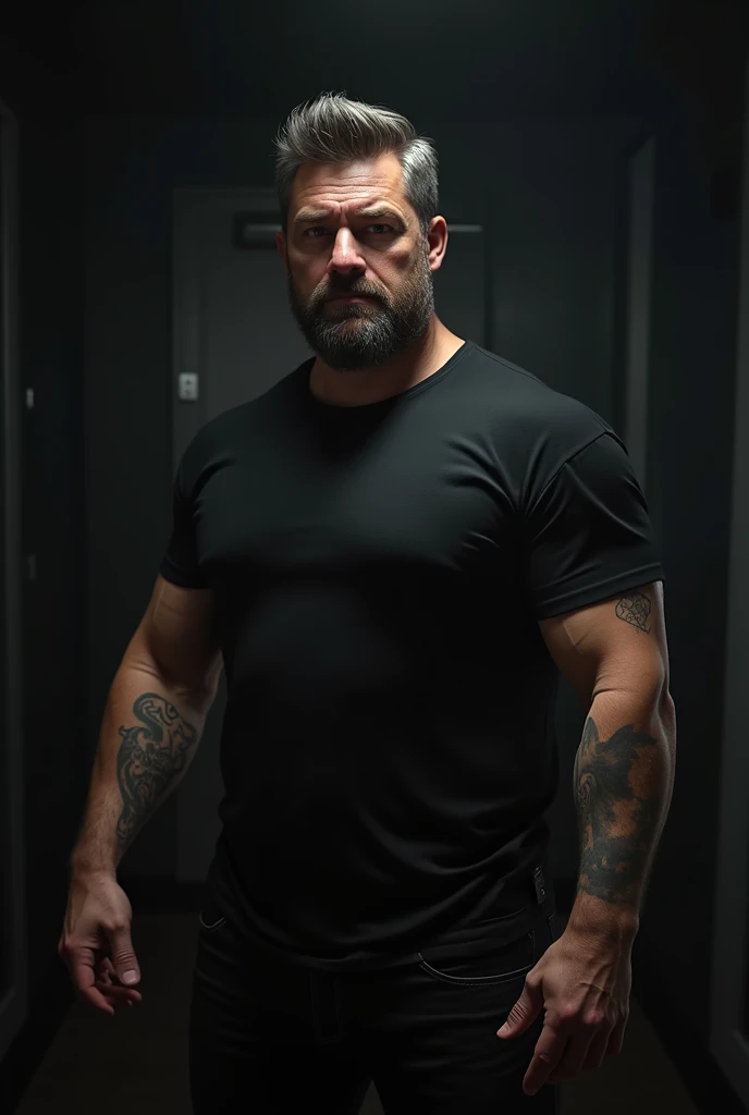 male, 5'6", Dark brown short hair with gray 2 level, Longer hair on top 4, Muscular arms, Tattoo on left upper arm, Short-sleeved black T-shirt, Medium build, Black jeans, Short and tight beard slightly graying, In a very dark room, Average looking,