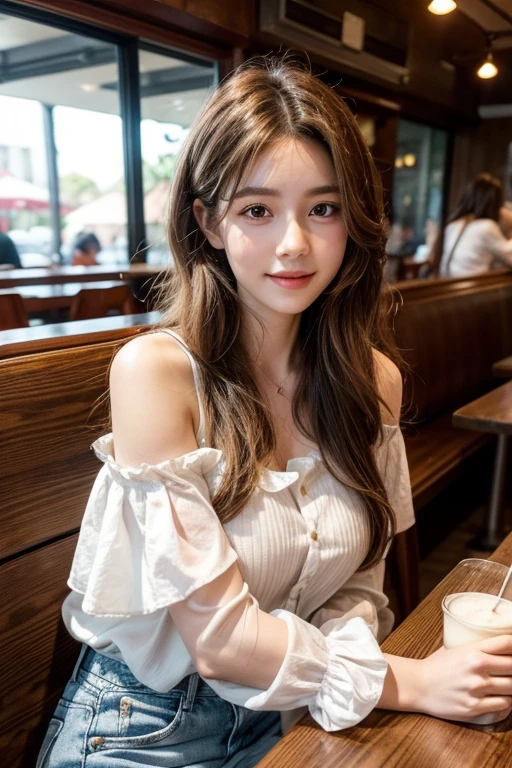 The image is a portrait of a young woman sitting on a bench in a restaurant. She is wearing a white blouse with ruffled sleeves and denim shorts. Her long brown hair is styled in loose waves and falls over her shoulders. She has a serious expression on her face and is looking off to the side with a slight smile. The background is blurred, but it appears to be a busy restaurant with other people sitting in the background. The overall mood of the image is relaxed and casual.