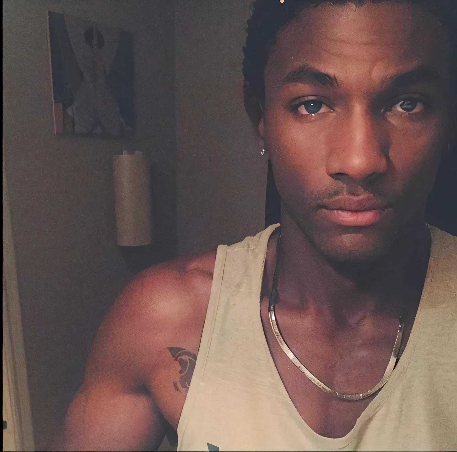 there is a man with a tattoo on his chest and a white tank top, black teenage boy, riyahd cassiem, dark skinned, inspired by Terrell James, dark-skinned, around 1 9 years old, with brown skin, photo in style of tyler mitchell, he is about 2 0 years old, he is about 20 years old