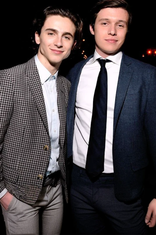 Two young men standing next to each other, very skinny, bare legs, wearing a diaper