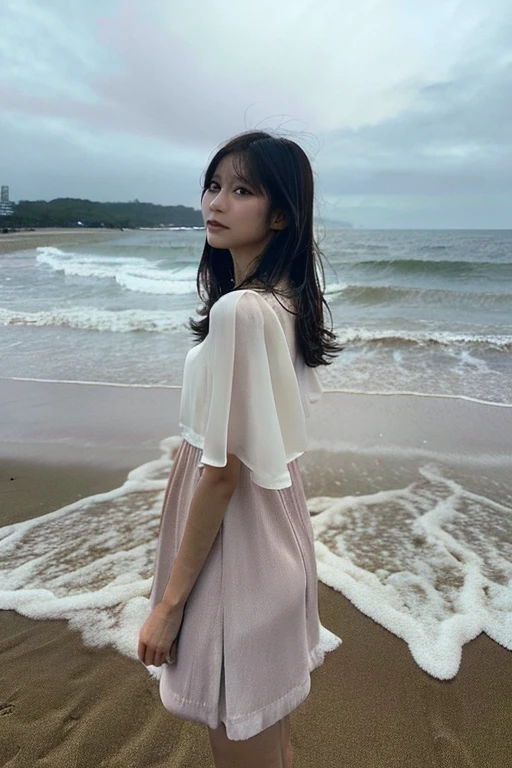 Girl standing on the beach alone