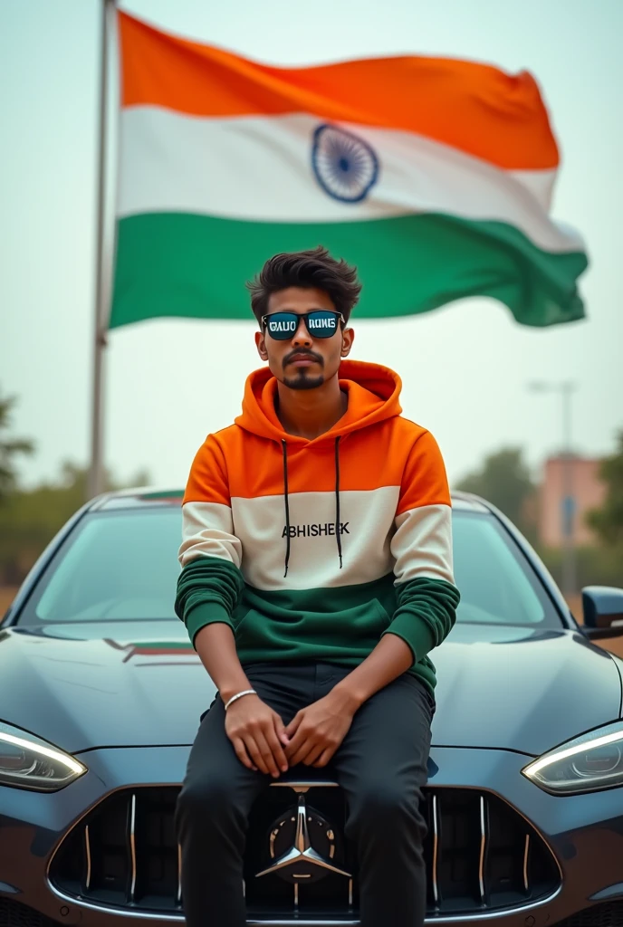 Create a realistic photo of a 14 year old boy sitting on the car, wearing a indian flag color hoodie, sunglasses with the name 'NISHANT’ printed across it. The background features a Indian flag fluttering in the wind.”