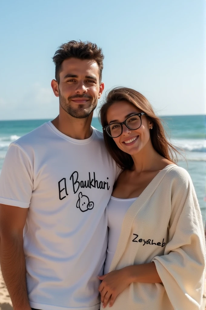 A slightly tanned young man with something written on his shirt "El Boukhari" A civil engineer standing next to his beautiful architect wife, who is white and wearing glasses, with something written on her blanket "Zeyneb" . 
and they are carrying their beautiful little daughter