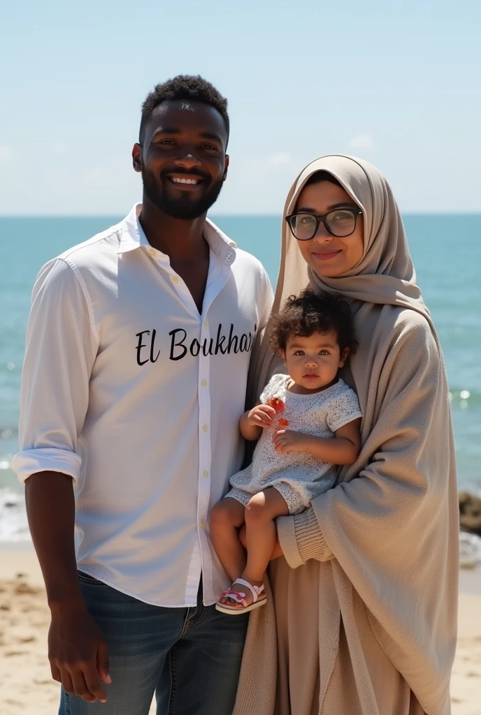 Dark skinned young man with writing on his shirt "El Boukhari" A civil engineer standing next to his beautiful architect wife, who is white and wearing glasses, with something written on her blanket "Zeyneb" 
By the sea, the weather is beautiful, the wife is a Muslim and modest, and they are carrying their beautiful  daughter.