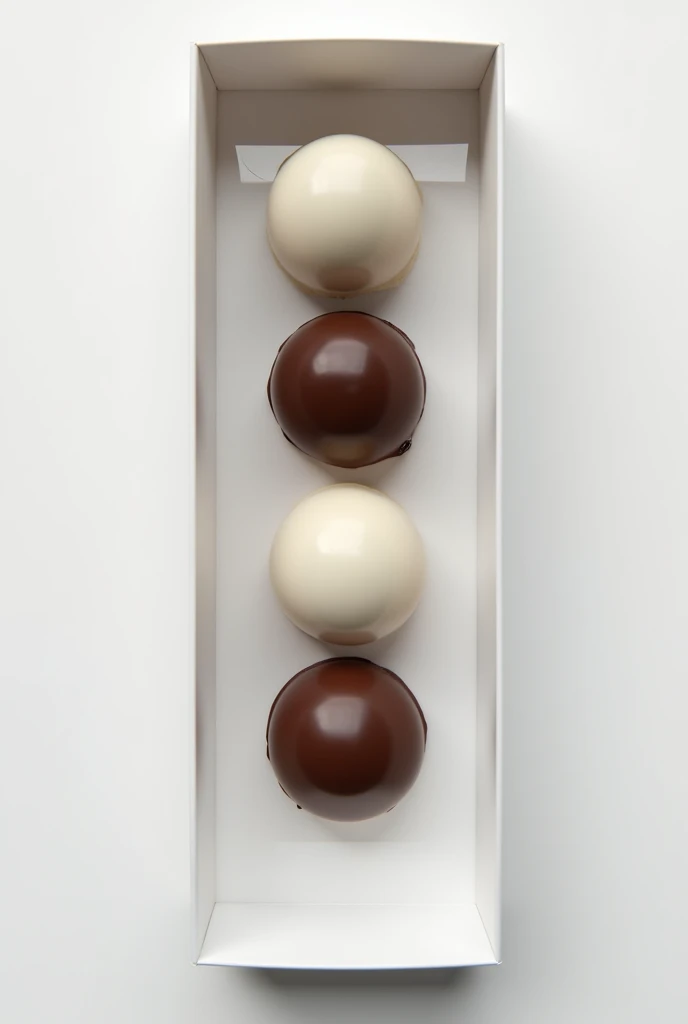 Round white-bottomed chocolates
Arranged in a row inside a white box with a transparent square so the chocolates are visible inside 