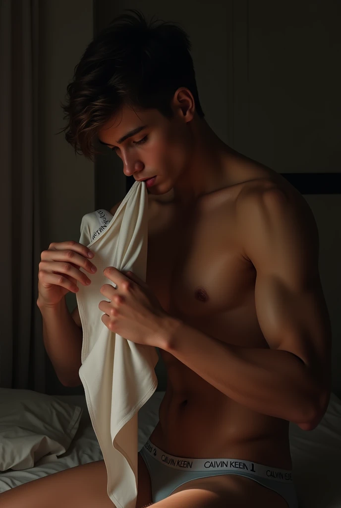 A young man sniffing Calvin Klein boxers