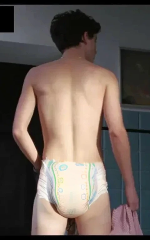 Diaper, pampers pattern, diaper mess, Realistic photo of Timothée chalamet, young man, male, very skinny, bare legs, standing, view from behind, wearing a diaper