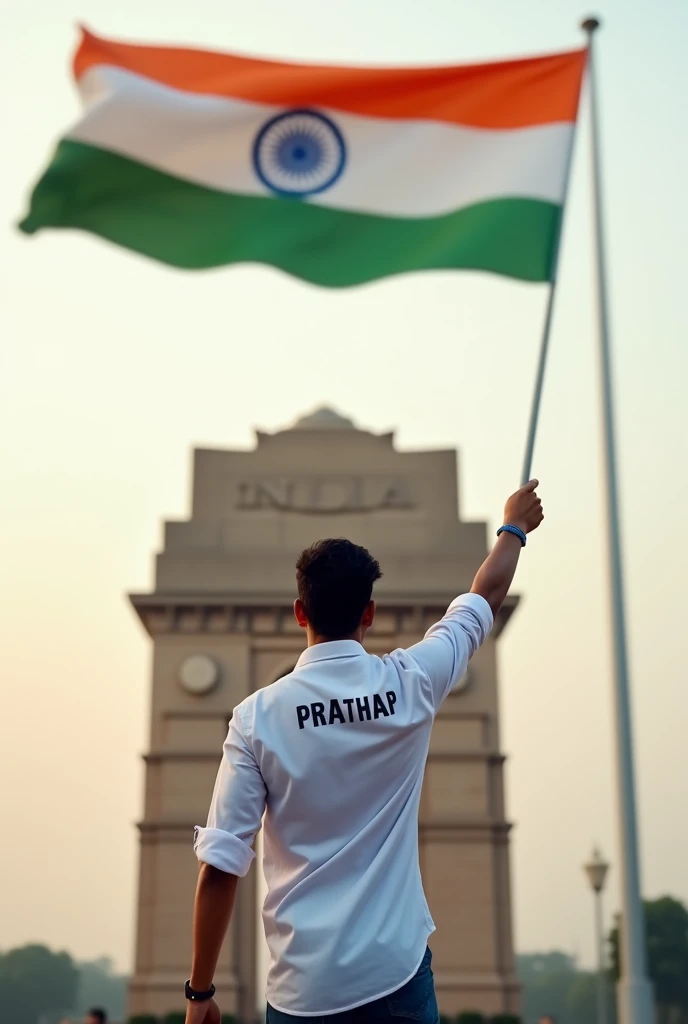 Indian Flag in height of the India gate one 25 years old boy flag salute in right hand that boy wear white colour shirt back side of the shirt named PRATHAP