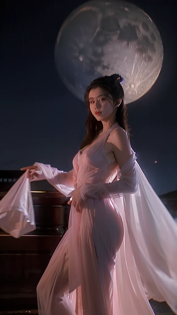 A Chinese woman in an ancient pink, translucent dress stands in the midst of an ancient Chinese city. Her entire front side is visible against the backdrop of a cool, moonlit night with a full moon.