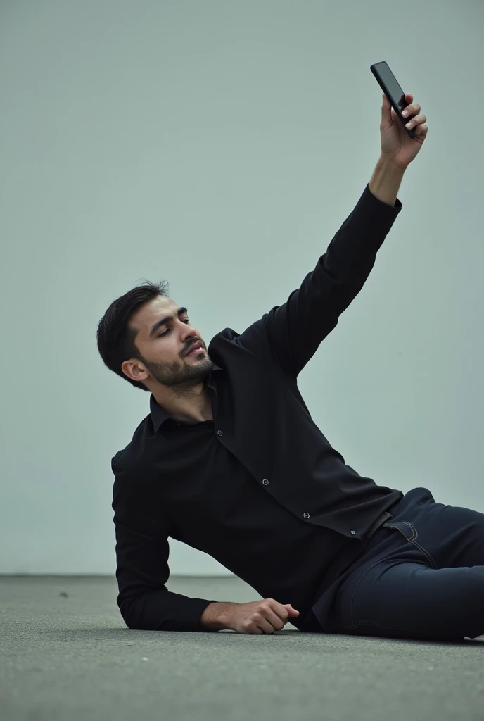 A man crawling on his face with one arm raised holding his phone filming himself as his head touches the ground