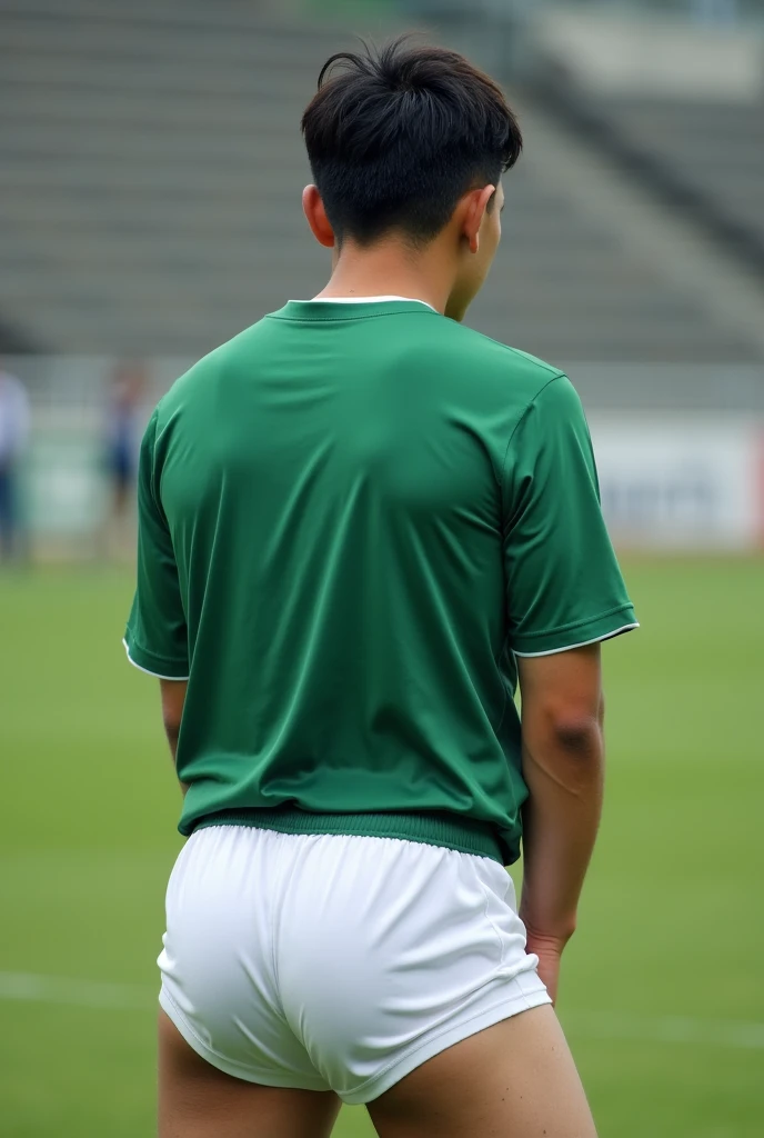 Man, wearing white football shorts, bending over, panty line, green football shirt, white shirt, front field, Asian, black hair, panty line,