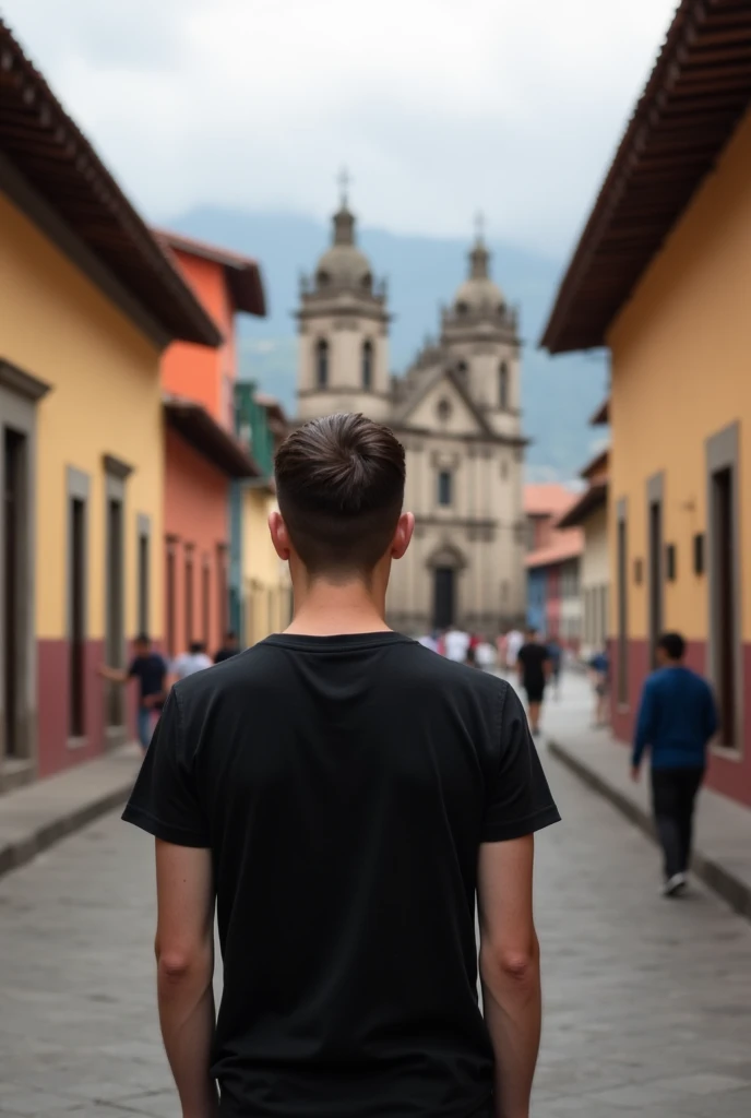 Young man with black t-shirt from behind in the historic center of Cuenca, Ecuador