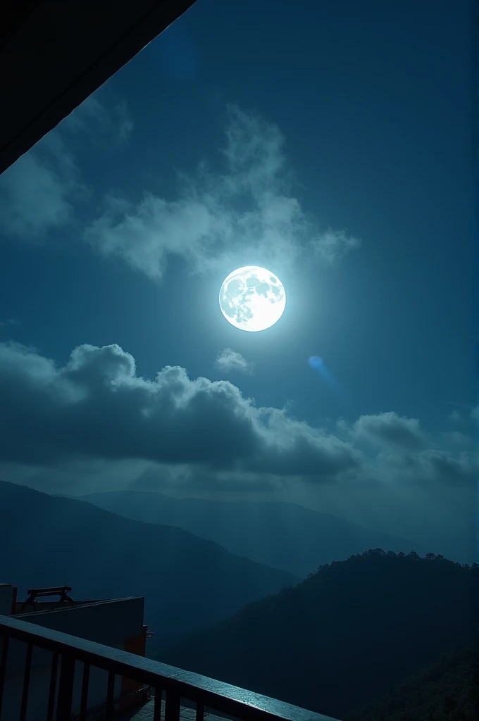 a photo taken from a terrace with a full moon surrounded by clouds