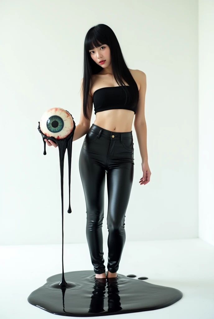 An Asian woman in shiny black tight pants and a shiny black tube top, with long straight black hair and bangs, stands with her right hand holding a hand-sized eyeball with black liquid coming out of it, at chest level. Her body is slightly covered in black liquid, and the ground has black liquid swirling around her. The background and ground are plain white.
