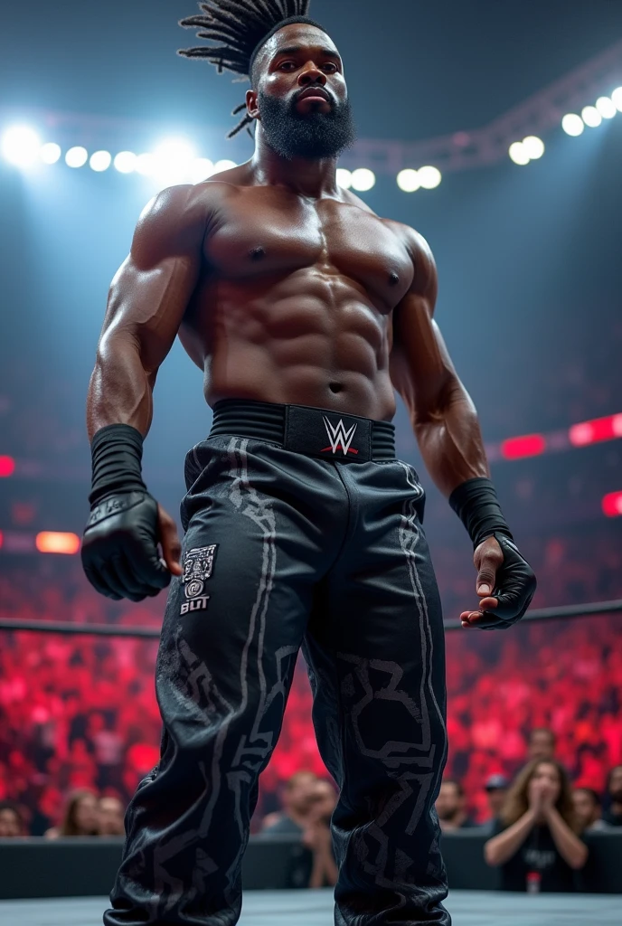 Fighter Kofi Kingston with a serious expression, wearing long pants in black and gray with the BMU logo