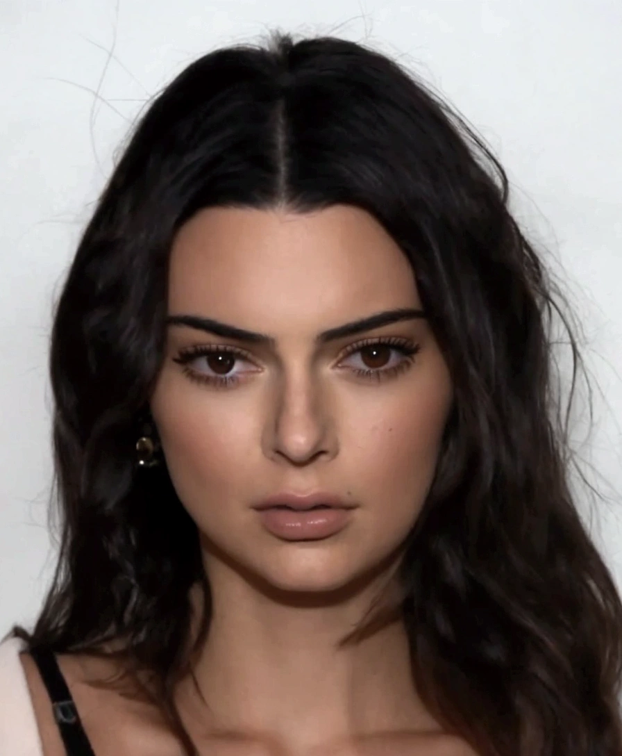 a close up of a woman with long hair and a black bra top, kendall jenner, emily ratajkowski, dua lipa, portrait emily ratajkowski, mean smirk, christina kritkou, sexy face, confident smirk, she is facing the camera, mean look, taken in the early 2020s, sultry smirk, flawless face