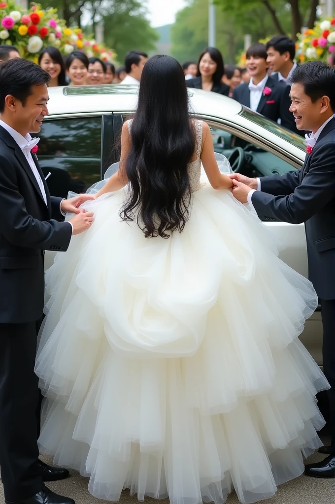The pretty Japanese bride is desperately trying to get out of the car. She's on her stomach and trying to get out of the car on all fours. She is wearing a huge fluffy tulle dress and looks like she is in pain, buried under that huge skirt, completely underneath. The skirt has caught on the car door and several people are trying to pull the dress to get her out of the car.