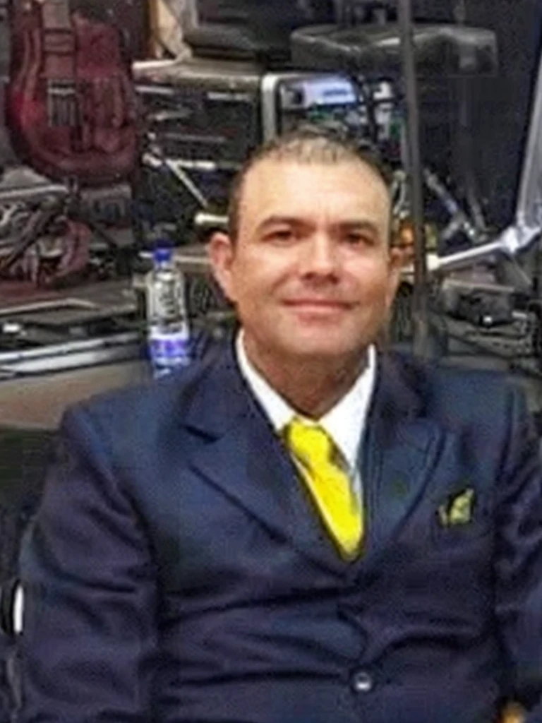 FoHigh resolution, 51 year old man, with dark blue suit and yellow tie sitting in a futuristic office