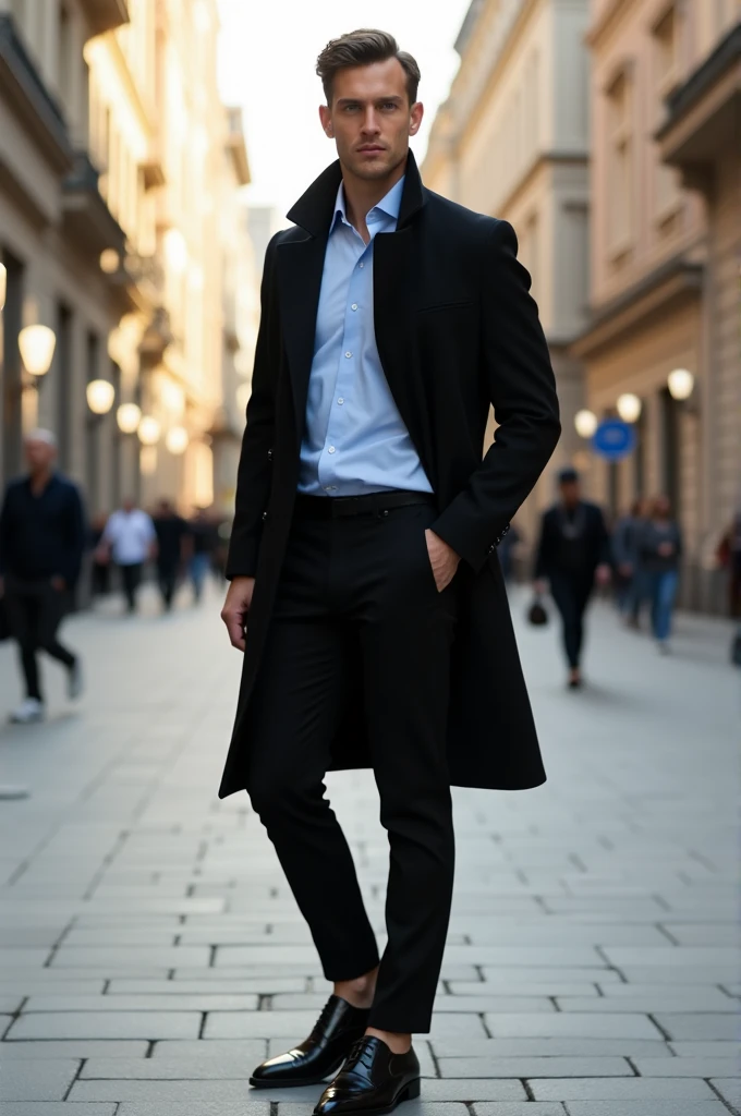 A man with black oxford shoes, black pants, baby blue shirt and black coat 