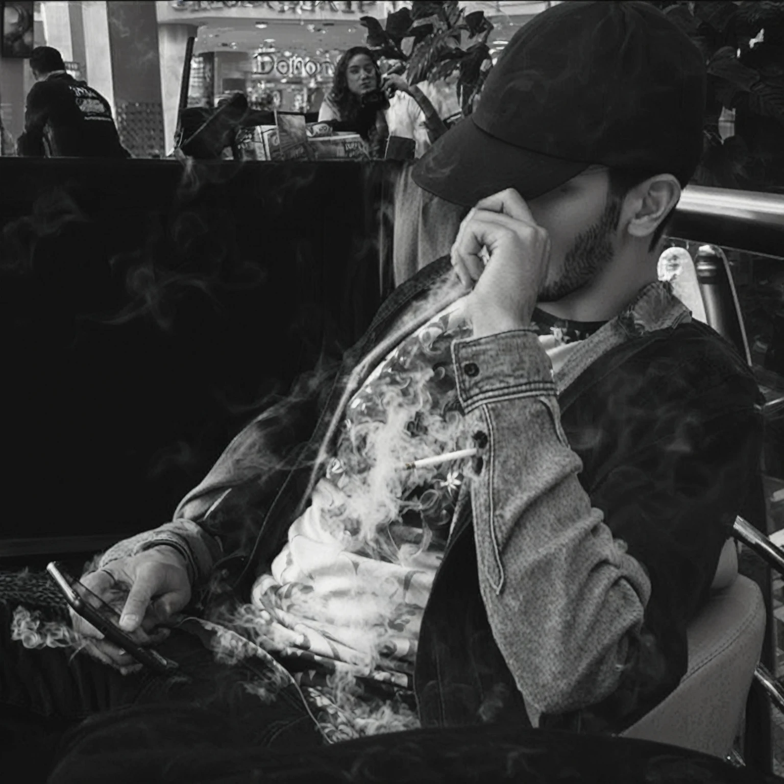 Arafeth sits in a chair and talks on his mobile phone, taking a smoke break, I look at my phone, provocative photo, thick Smoke around him, deep in thought, in thoughts, in the mall, Smoke around him, bored, in the mall, high quality download, smokes, он smokes сигарету, to sit carelessly