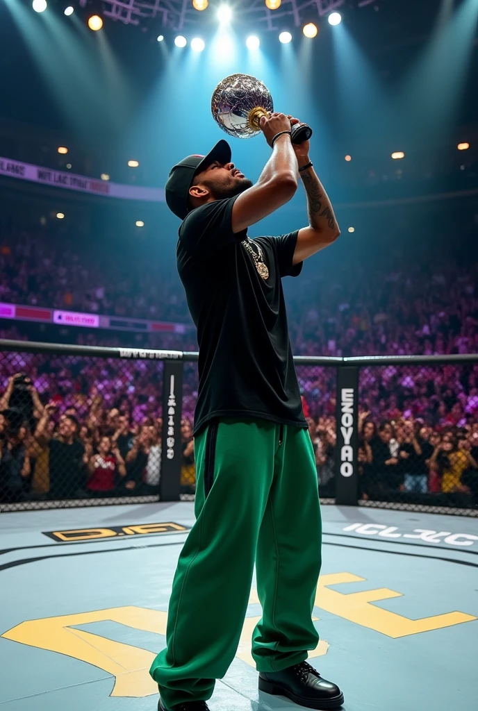 In the UFC ring, a rapper with a black shirt, long green pants and black shoes and a black cap with the flamengo symbol is in a UFC ring kissing the champion trophy 