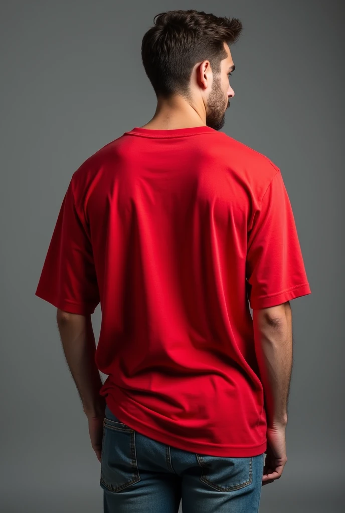 Handsome man, standing straight facing at back,wearing red colour oversized t-shirt, denim pants, against greyish background, cotton texture of t-shirt, oversized tshirt,round neck, half sleeves. Cotton texture of t-shirt should be visible little bit.