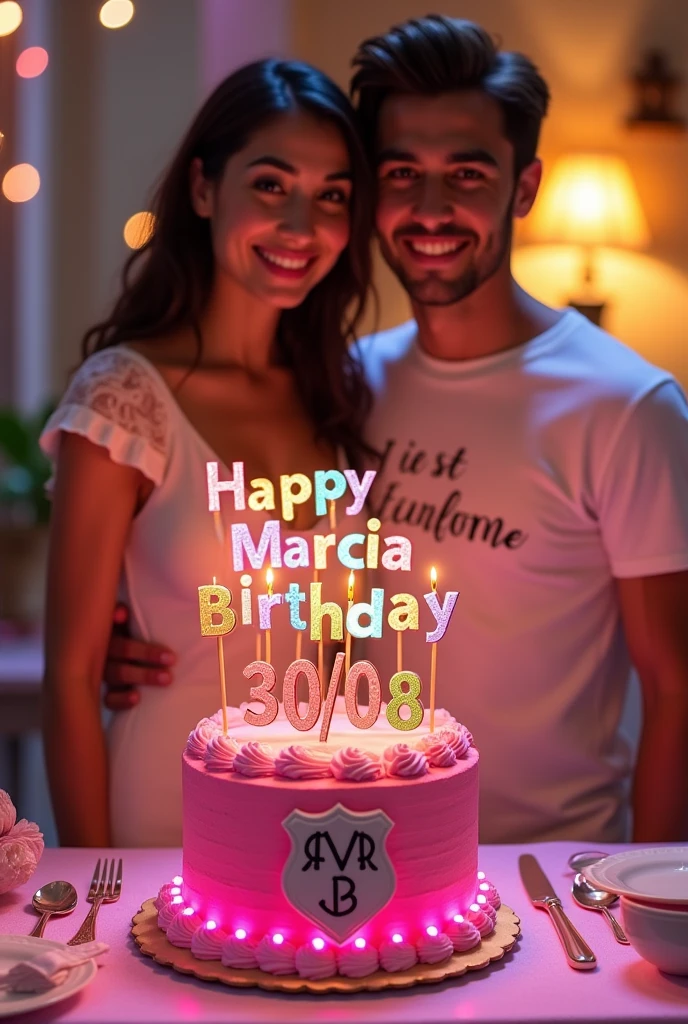 An abstract animation with a pink birthday cake with a shield of the letters M.M.g.B as the main decoration !! On top of the cake in different letters " Happy birthday Marcia Monteiro" Following the date 30\08. The cake is in a lit room. With a birthday girl behind the table with the name Márcia written on her blouse, and her boyfriend next to her with the name Pedro Mawete on the t-shirt.