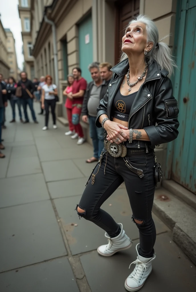russian old milf woman, biker gang member, long grey hair (bump, quiff and ponytail) with very light blue eyes, extremely pale. Thin. Sad, humble face. Wearing cropped black moto jacket with side zippers, black cropped tank top with pentacle logo, skinny black jeans with holes and white tennis sneakers. Lots of metallic bracelets. Chains. Tacky studded leather wide belt with massive skull and bones buckle . Both hands in prayer. Demonic tattoos. Lots of rings. Long earrings. Looks up with amazement because she thinks God is talking to her, mouth and eyes open. Skinny legs, narrow hips. People  near her are looking at her