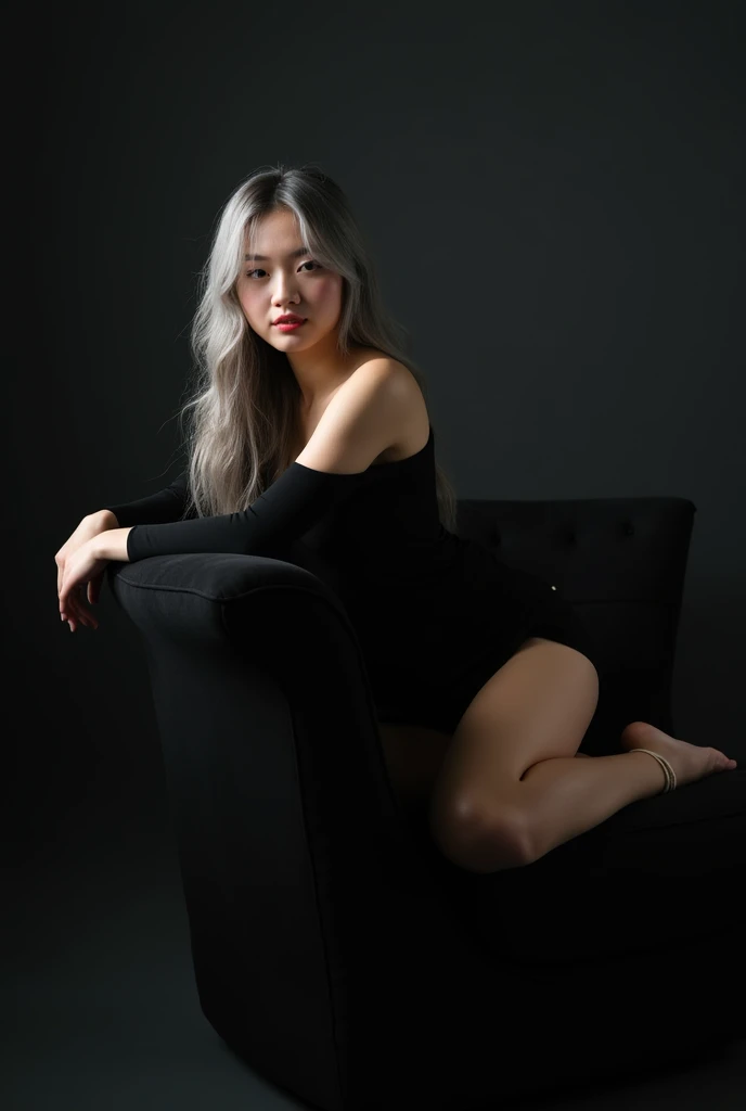Girl sits elegantly on modern black soft chair, looks straight, Sits up straight, Against the background of a dark room, black off shoulder top, light gray long hair, good lighting, realistically, photo
