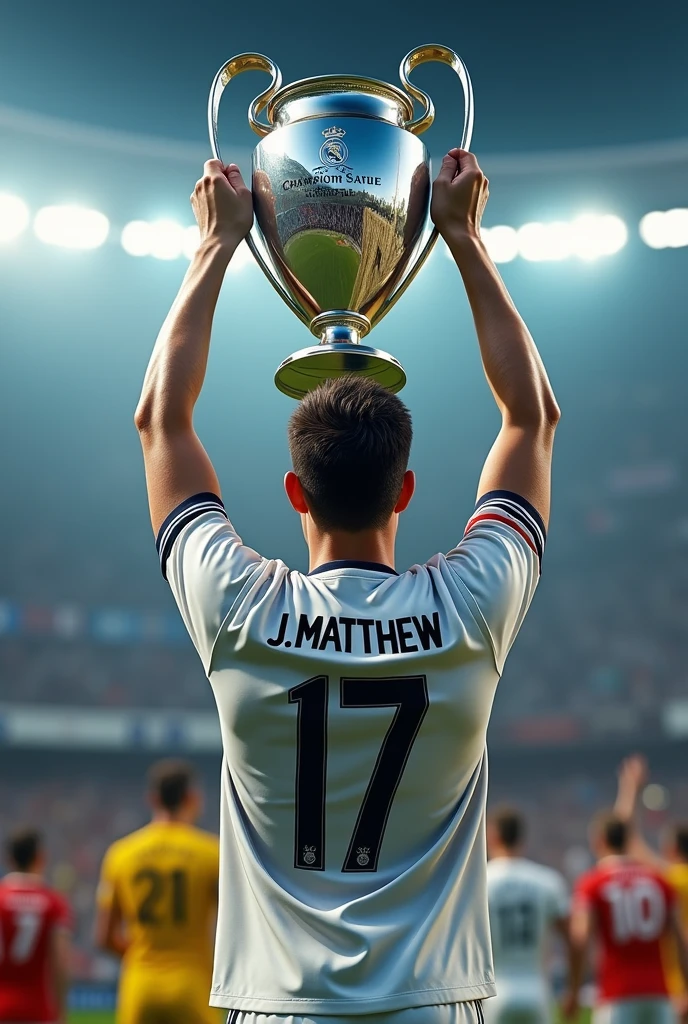 A young man holding up the Champions League trophy with a Real Madrid shirt, with the number 17 and the name J.MATTHEW from behind