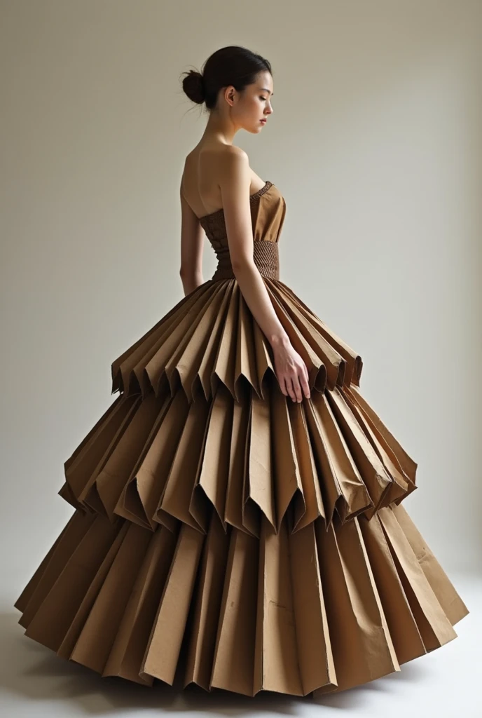 A girl wearing a ball gown, a long dress with a cut at the shoulders and a low neckline, exposed arms and long, puffy skirts, made of cardboard in different colors, such as brown and dark brownish.