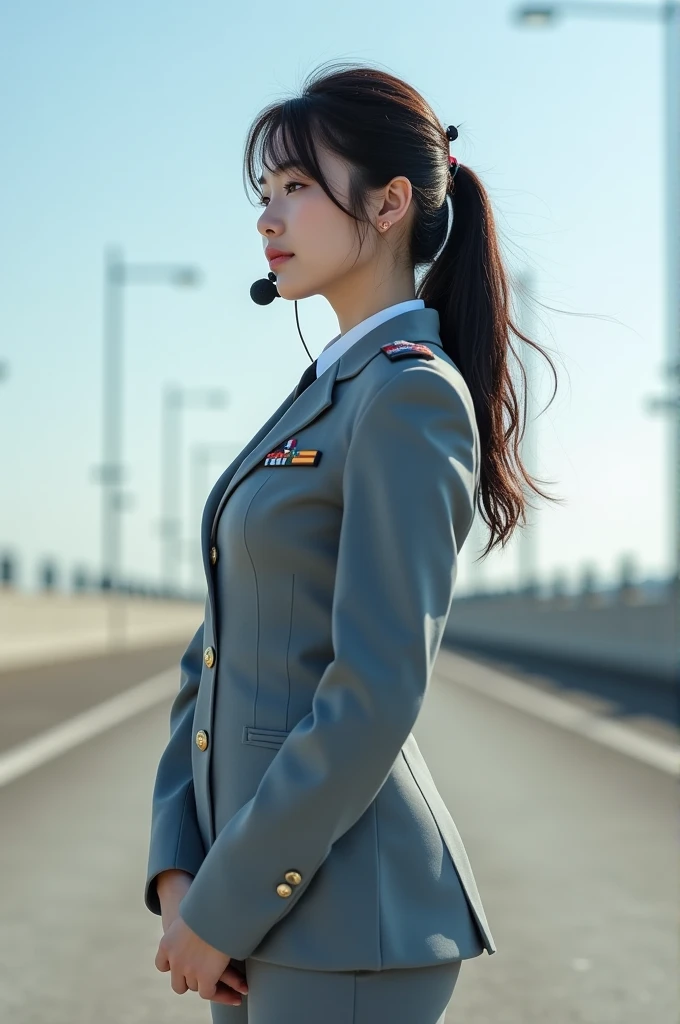 (Photorelism)), ((surrealism)) 8k, contrast, natural, pure realistic "A gorgeous Japanese woman in an Airforce uniform stands with her waist is in belly. She has a pretty face with Asian features, slightly fuller in build with a big boobs, showing her cleavage and her full body. Her uniform is a beautifully tailored gray Airforce outfit, complementing her figure. She wears a small black mic on her face. The background is simple, featuring a clear sky and a cement road beneath her feet."