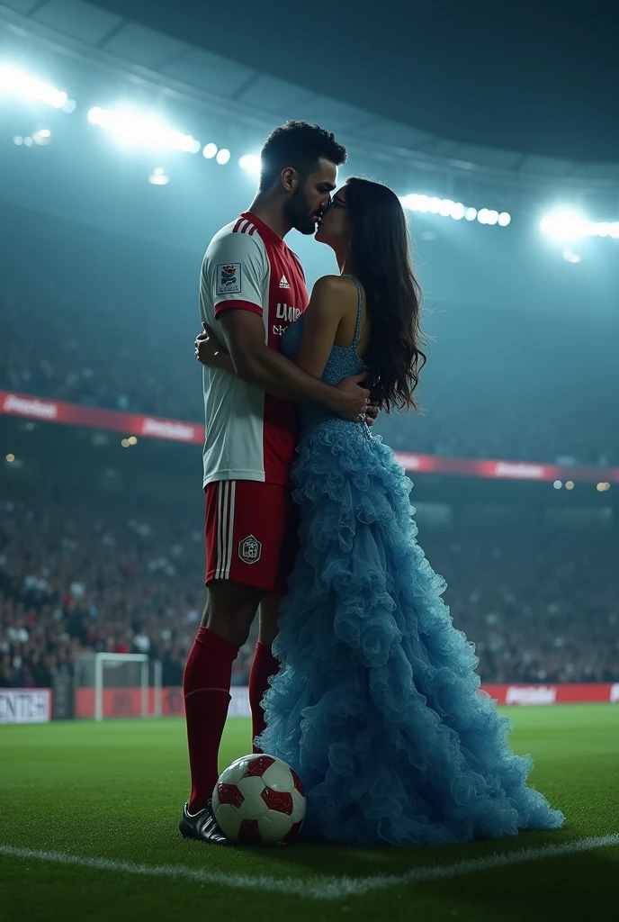A man and woman kissing eachother in football stadium ground at night time all spot light on them woman is wearing glasses and had black hair . Woman is wearing blue dress high heels and a lab coat over dress. Man is wearing white and red colour 32 number jersey. Siddharth written on jersey. Woman is cupping man s face . Man s one foot resting on a soccer ball. Man is 1 feet taller than woman. Add some audiance in stedium . Make man s tall than woman . Make it realstic..make boy handsome . Make dress long, floral and fluffy. Remove lab coat. . Man is tall . Man and woman doing make out . They are kissing each other passionately.