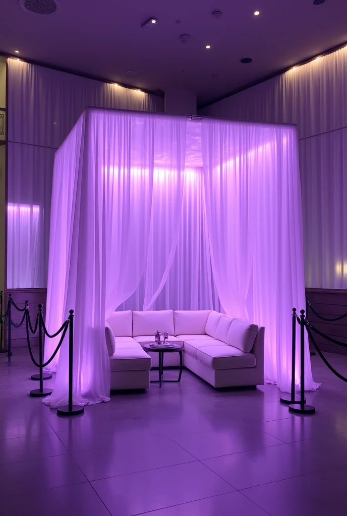 an interior environment with predominantly purple lighting. At the center, there is a square structure with translucent curtains also in shades of purple. Dentro dessa estrutura, there are white sofas arranged around a small table, creating an intimate and reserved space. Around the area enclosed by the curtains, there are black rope barriers, suggesting that the space is exclusive or VIP. The environment is modern and elegant, with a sophisticated atmosphere created by the combination of soft lighting and minimalist furniture design.