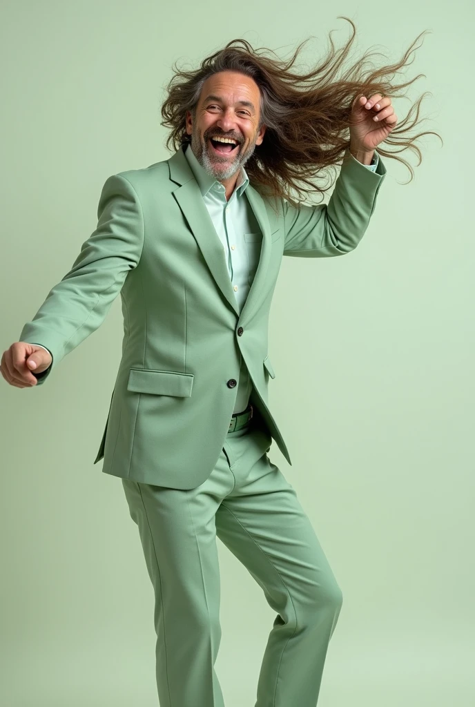 "A happy man, with lots of hair, is wearing a light green suit. He is playing with his hair and the image shows his entire body.. 