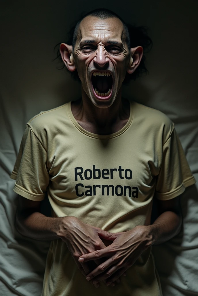 Thin dark-skinned man with a face with rat-like features and a shirt with the name Roberto Carmona on it but without pants and who grabs his penis in a lying position in an excited manner. 
