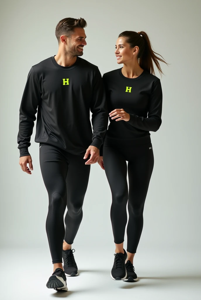 General image of a man and woman wearing black long-sleeved sports outfits and leggings with a lemon green H letter logo