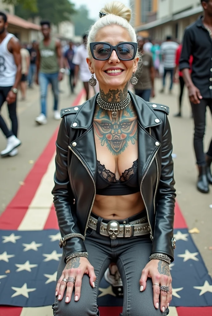 Anglosaxon old milf woman, , blonde platinum hair (beehive bun, black parsley headband), with very light green eyes, extremely pale. Wearing oversized square black maxisunglasses Wearing studded cropped black moto jacket (verical zippers on the sides). Black lace push up bra, dark grey skinny low rise jeans (worn knees and crotch). Silver Chelsea boots with cuban heels. Lots of thick wide studded bracelets, chain collars and big rings. Tacky wide studded leather belt, with big skull and bones round buckle. Long earrings with chains. Squatting on a large ragged usa flag, looking at the photographer. Craving heavily. Hands on knees. Waste and trash on the floor. Looking at the camera, chin up. Toned abdominals, thin neck, slim legs and thin arms. Neck, chest, belly, hands and arms completely tattoed. Street of Nairobi, crowded with standing people