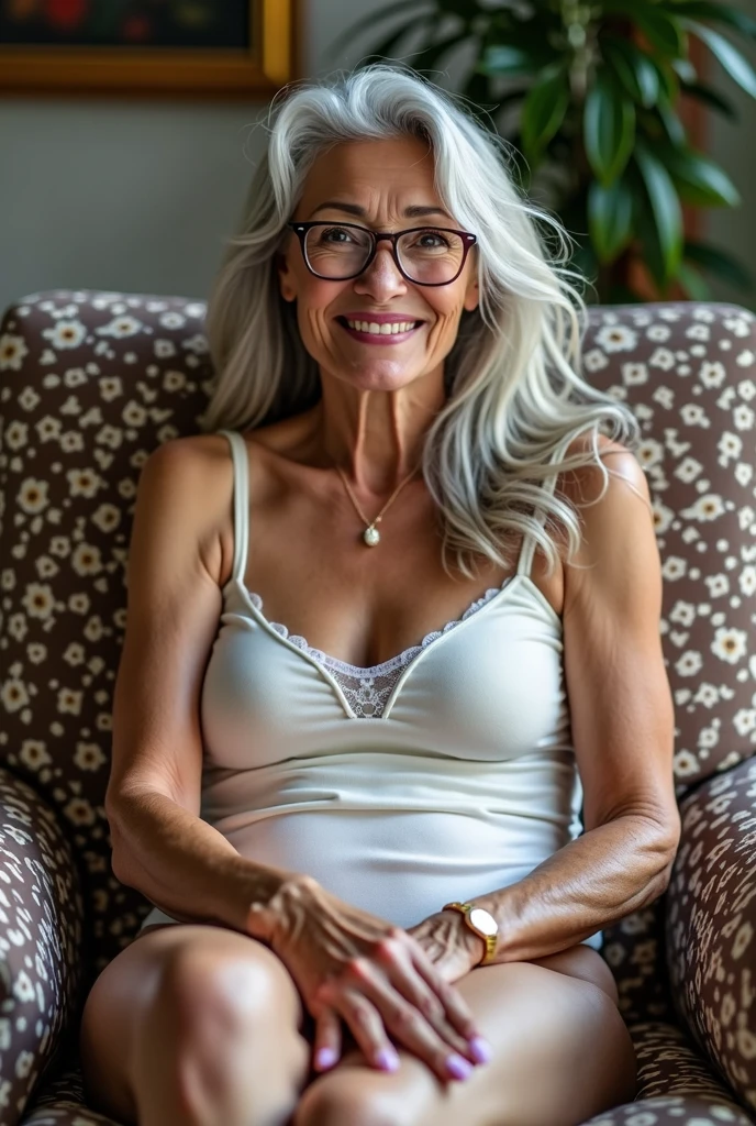 An elderly caregiver, in which you are looking for a job This photo shows an older woman with long, gray-white hair, wearing white lingerie. The woman has a bright smile, wears glasses, and sits in a patterned chair. Her body has natural wrinkles, reflecting her age and the changes her body has undergone over time. The overall image exudes confidence and comfort, with the woman expressing joy and satisfaction with her body.