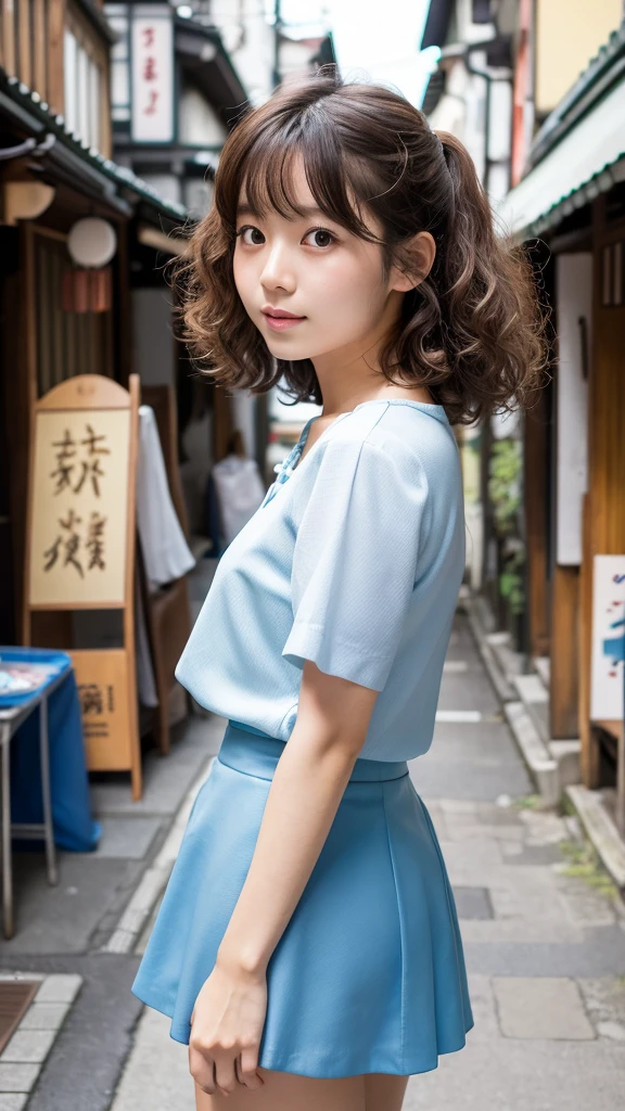 : A lovely Japanese girl with curly, shoulder-length hair, dressed in a light blue mini skirt and a white blouse. She is posed in a quiet, old-fashioned Japanese street lined with traditional shops.