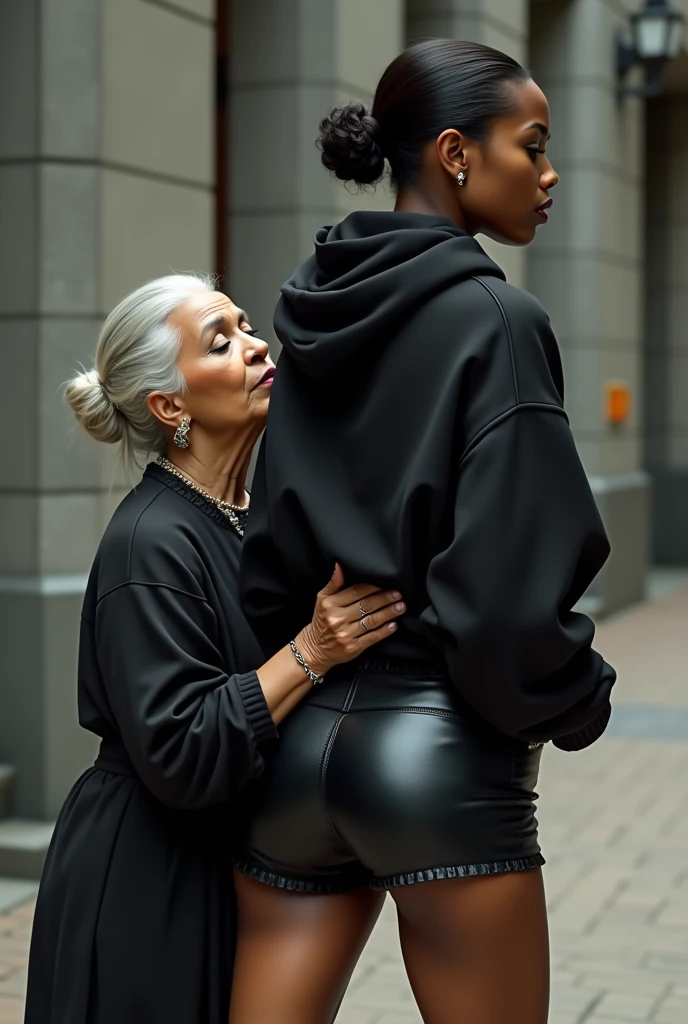black woman hair in a bun black hoodie black leather short shorts a old grandma in a dress on her knees kissing her ass behind her squeezing her butt