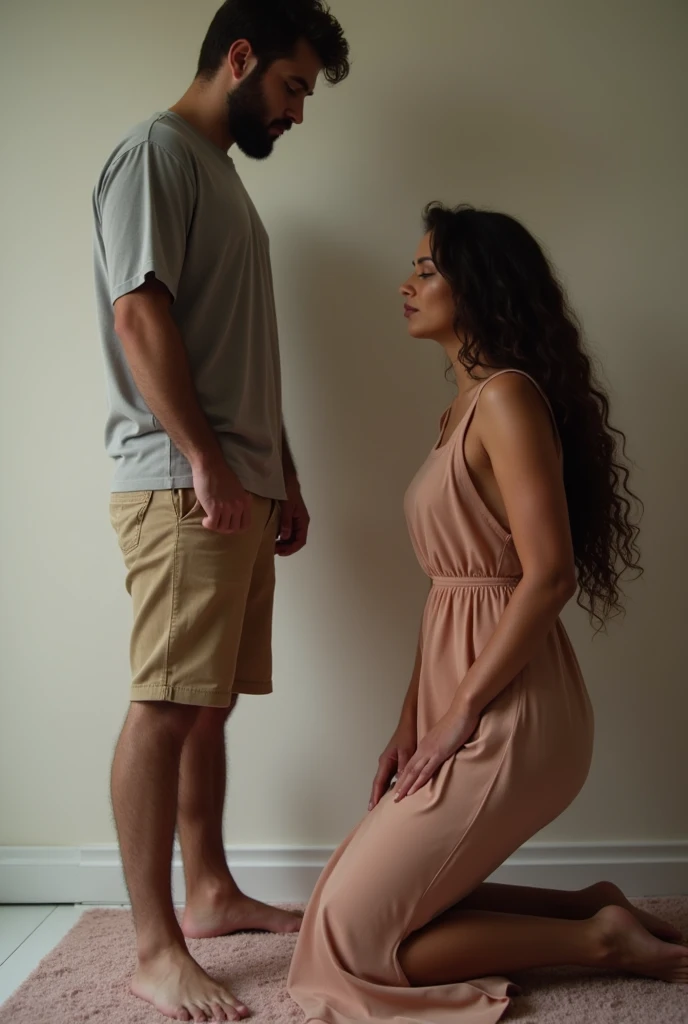 Beautiful wife with wavy long hair, elegantly dressed, kneeling with a submissive expression by her standing husband casually dressed