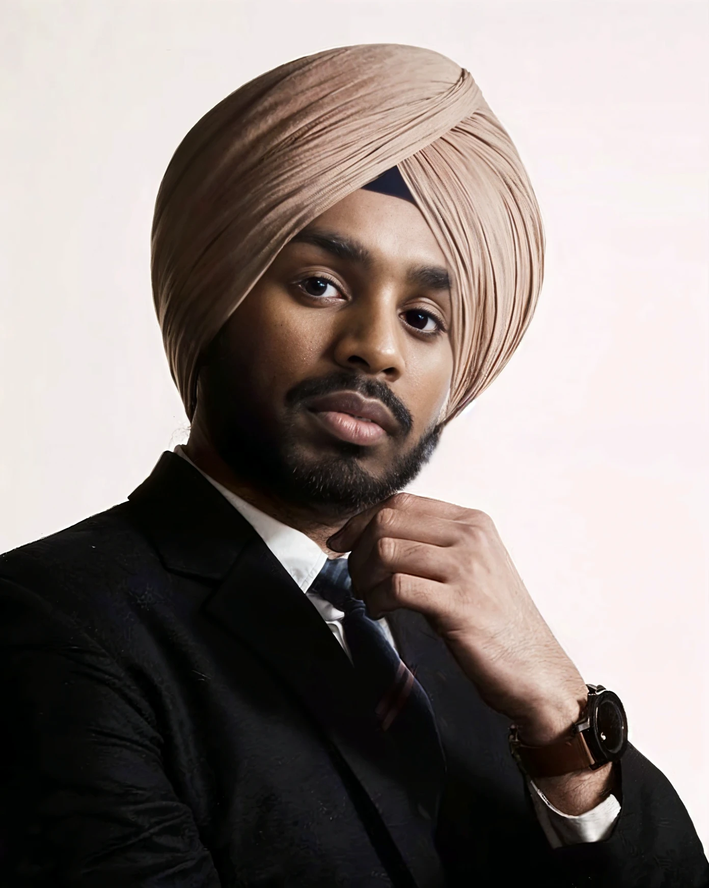 A young man with White hat on the head  into the head and a confident white punjabi 
And neem beard
He is dressed in a  over a white shigt.
The man is positioned against aqua colour backto
with a subtle red lighting on the left side.
and he posing for Linkedln profile