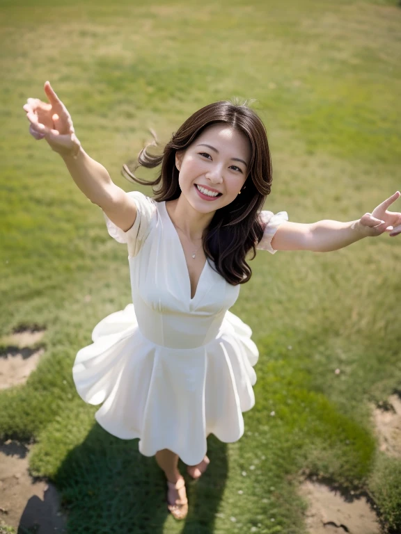 A drone-captured aerial view of a beautiful Japanese woman standing in an open field, looking up towards the sky with her arms fully raised in a joyful, celebratory gesture. The perspective is from directly above, highlighting the height and distance as the drone captures her entire body in the frame. She has a delicate and symmetrical face with soft, refined features that remain visible despite the top-down angle. Her dark, glossy hair flows around her as it is gently tousled by the breeze. She is wearing a flowing white dress that contrasts elegantly with the lush green grass beneath her, and her long, graceful legs are visible in the full-body shot. Her expression is serene and joyful, her large, expressive eyes gazing upwards as the sunlight casts soft shadows, enhancing the depth and realism of the scene. The aerial view emphasizes the sense of openness and freedom in the moment.
