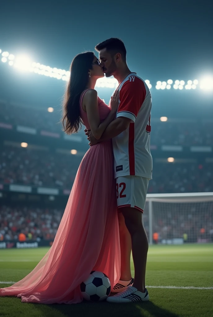 A man and woman kissing eachother in football stadium ground at night time all spot light on them woman is wearing glasses and had black hair . Woman is wearing long pink dress high heels . Man is wearing white and red colour 32 number jersey. Siddharth written on jersey. Woman is cupping man s face . Man s one foot resting on a soccer ball. Man is 1 feet taller than woman. Add some audiance in stadium . Make it real .make boy handsome . Make dress long and floral Man 2 feet taller than woman. Jersey number is 32. Add goal net in back ground . Make her hair set in straight  .woman is wearing  glasses make man 2  feet taller than woman 
