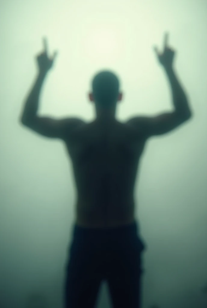 blurry silhouette of a man from behind with his arms raised making the rock sign